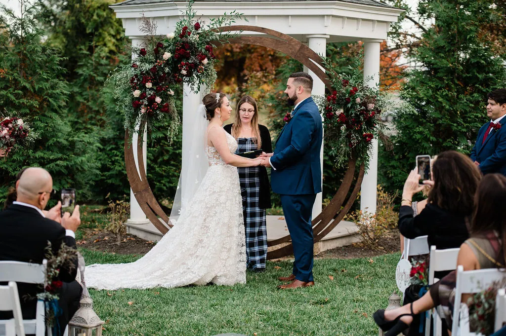 A ceremony under a floral arch